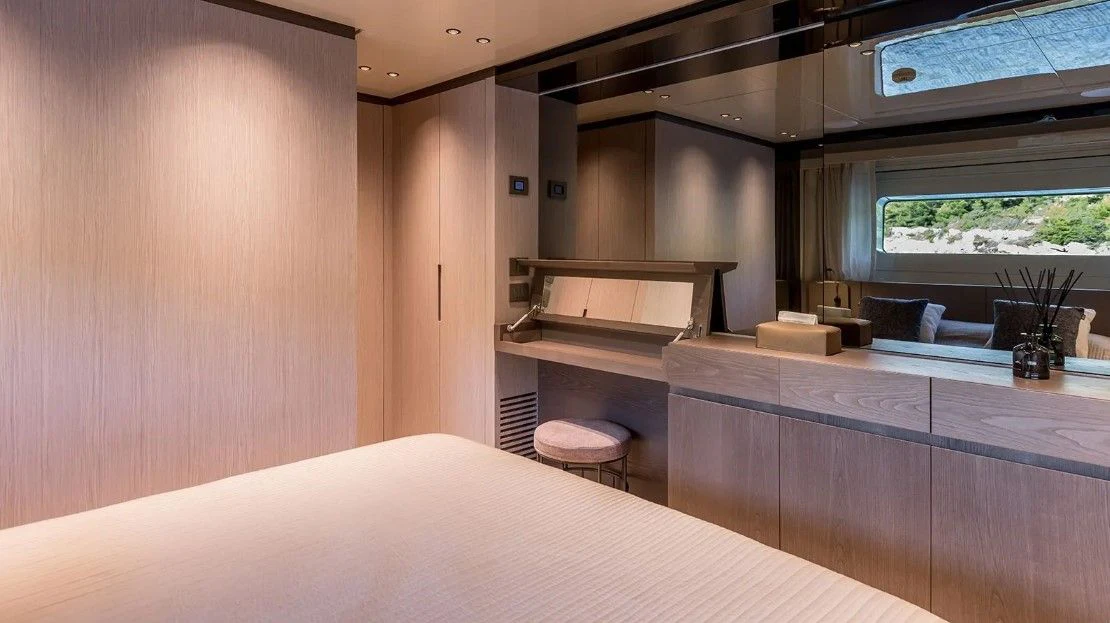 a room with a bed and a desk aboard EROS Yacht for Sale