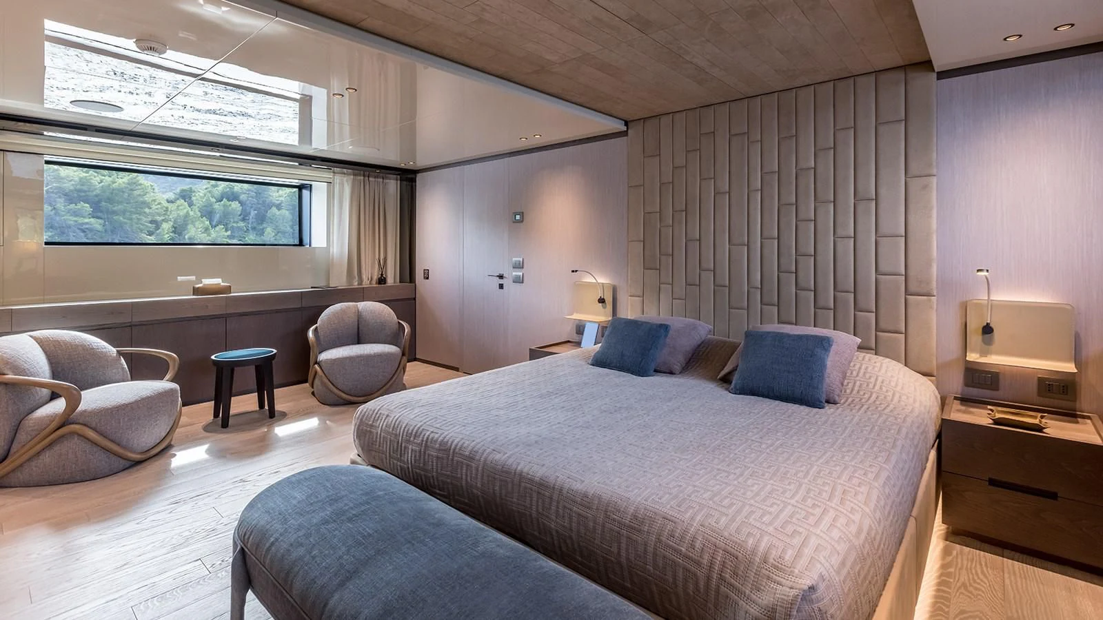 a bedroom with a bed and a chair aboard EROS Yacht for Sale