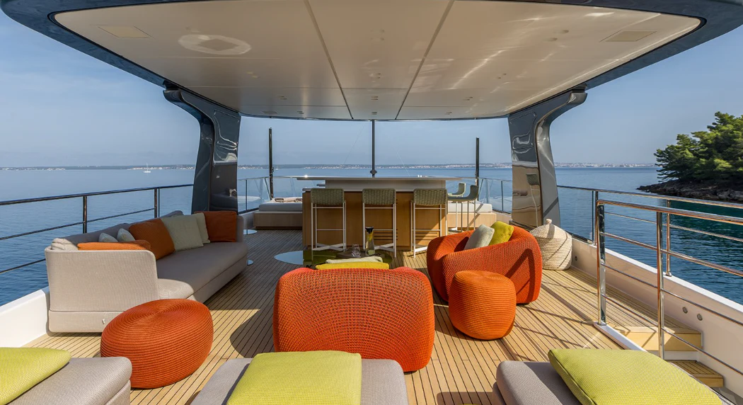 a large living room with a large balcony overlooking the ocean aboard EROS Yacht for Sale