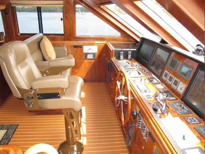 a room with a wood floor and a desk with a computer and a chair aboard AUSTRALIS Yacht for Sale