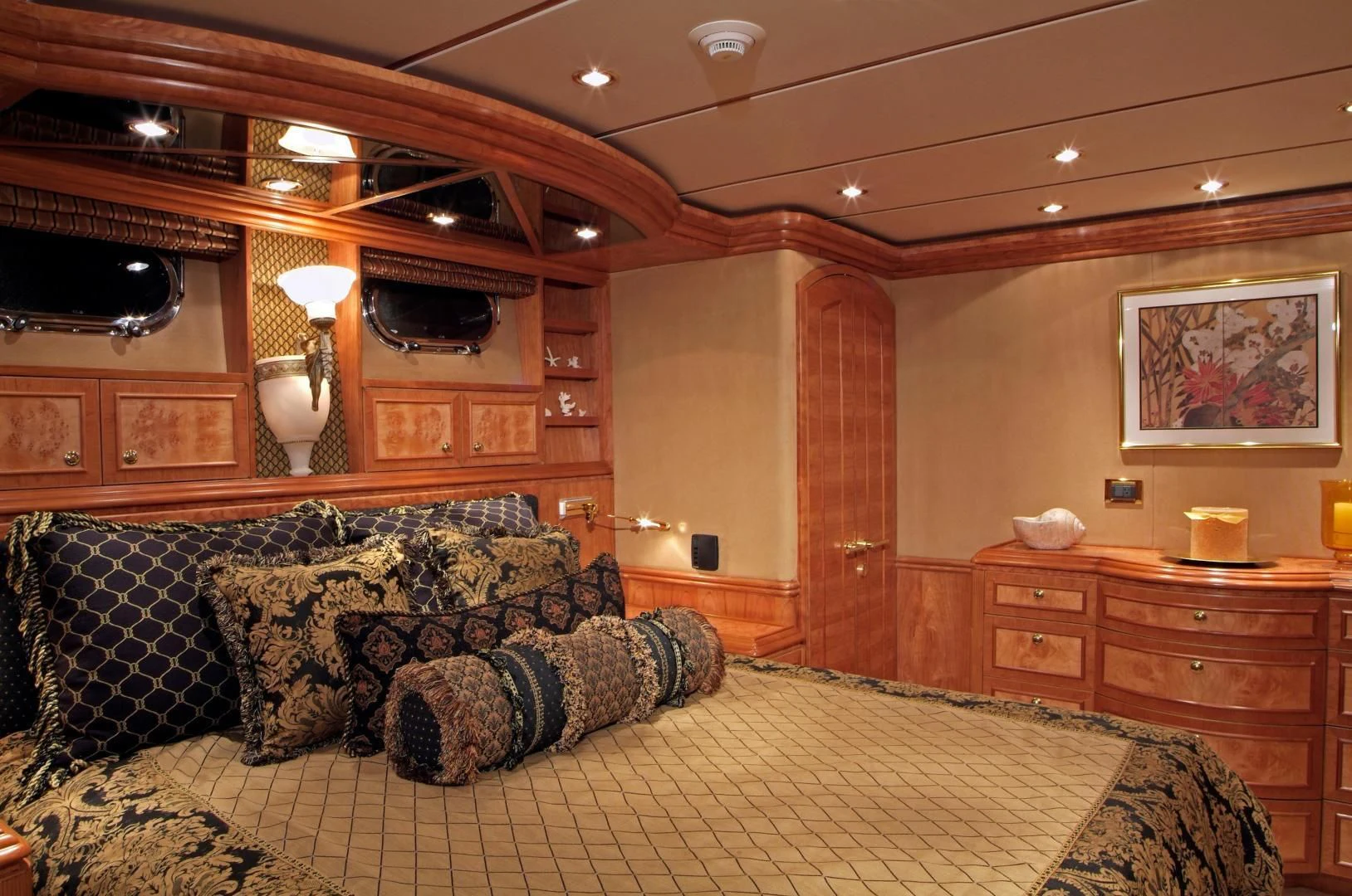 a large living room with a large sofa and a fireplace aboard AUSTRALIS Yacht for Sale