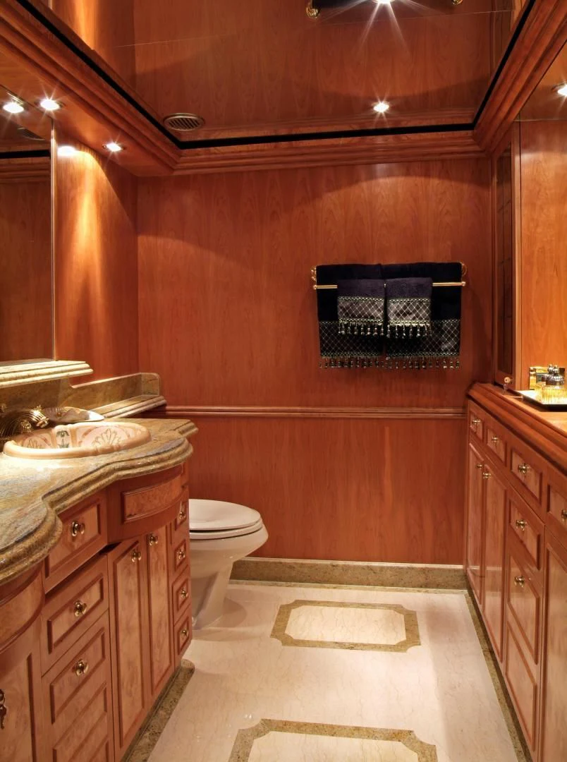 a bathroom with wooden cabinets aboard AUSTRALIS Yacht for Sale