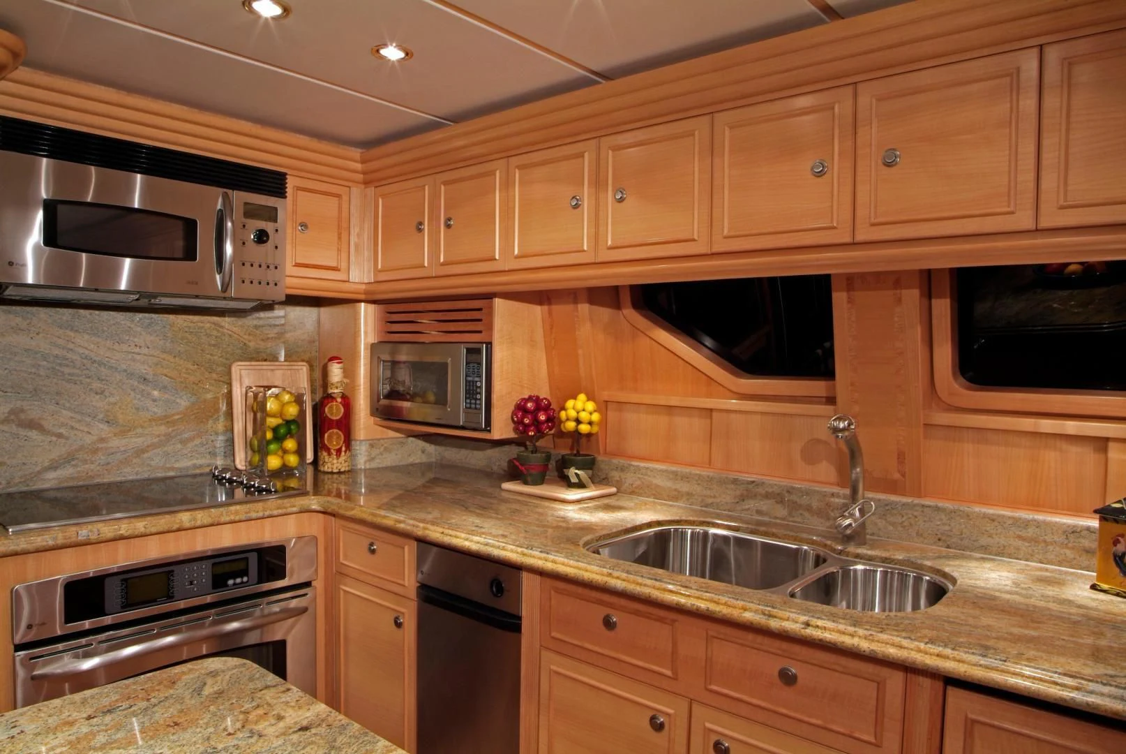a kitchen with wooden cabinets aboard AUSTRALIS Yacht for Sale