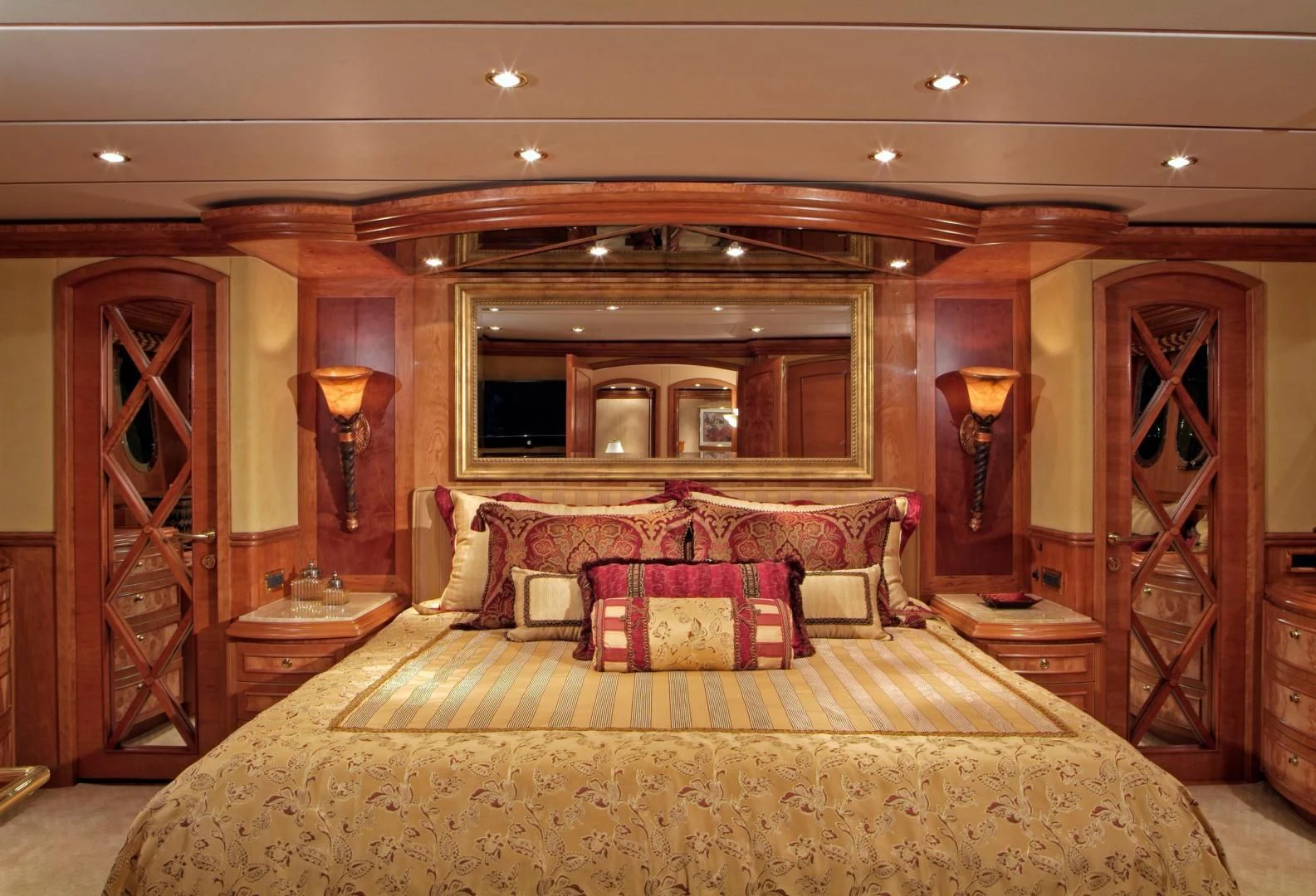 a large bedroom with a bed and a mirror aboard AUSTRALIS Yacht for Sale