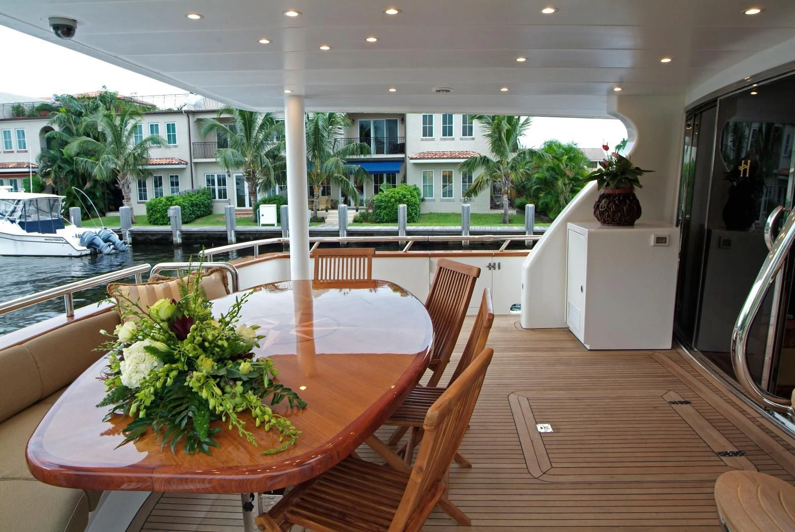 a table with chairs and plants on it aboard AUSTRALIS Yacht for Sale