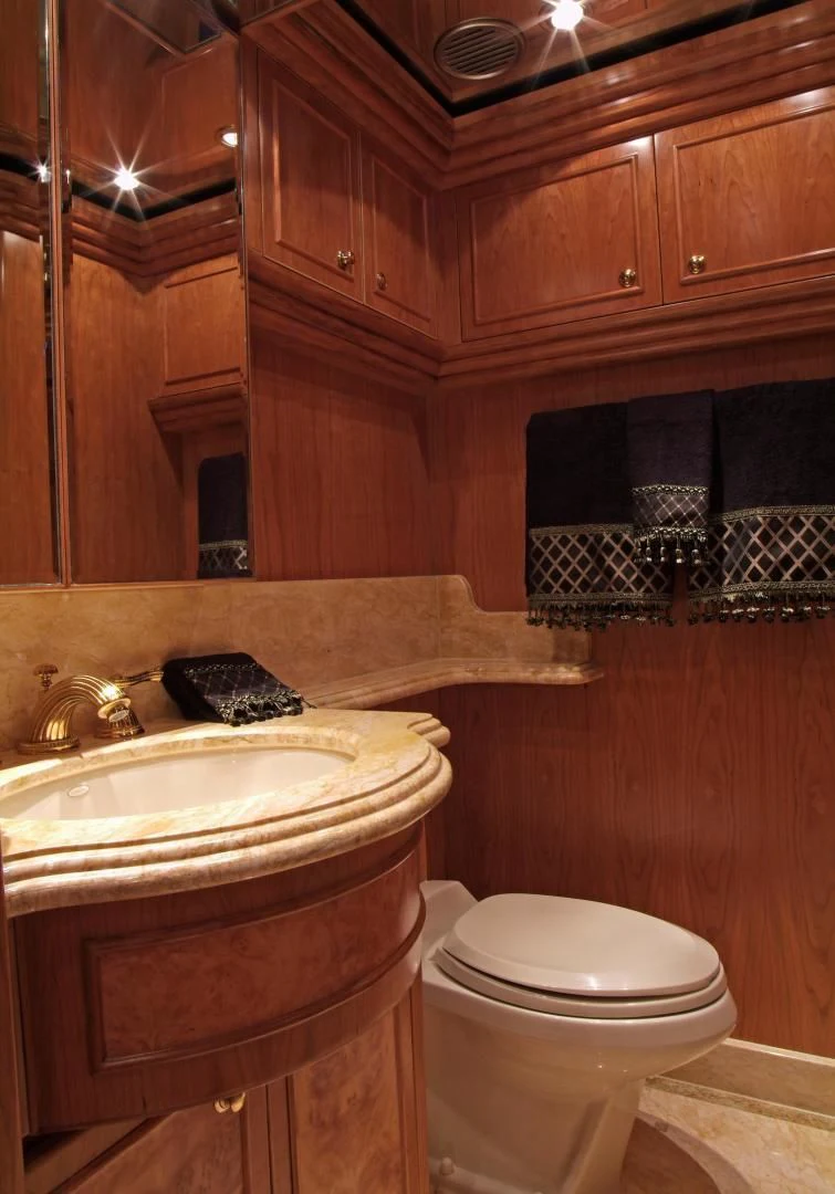 a bathroom with wooden cabinets aboard AUSTRALIS Yacht for Sale