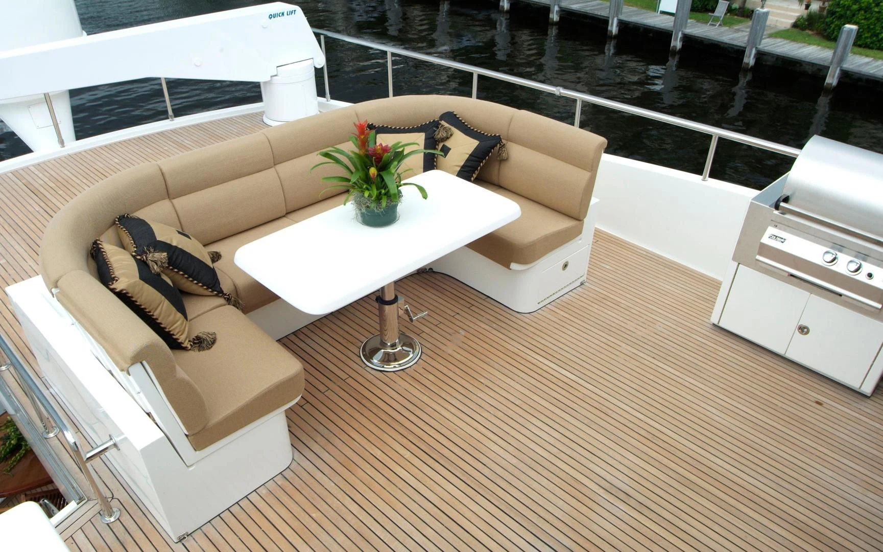 a room with a couch and a table with a plant on it aboard AUSTRALIS Yacht for Sale