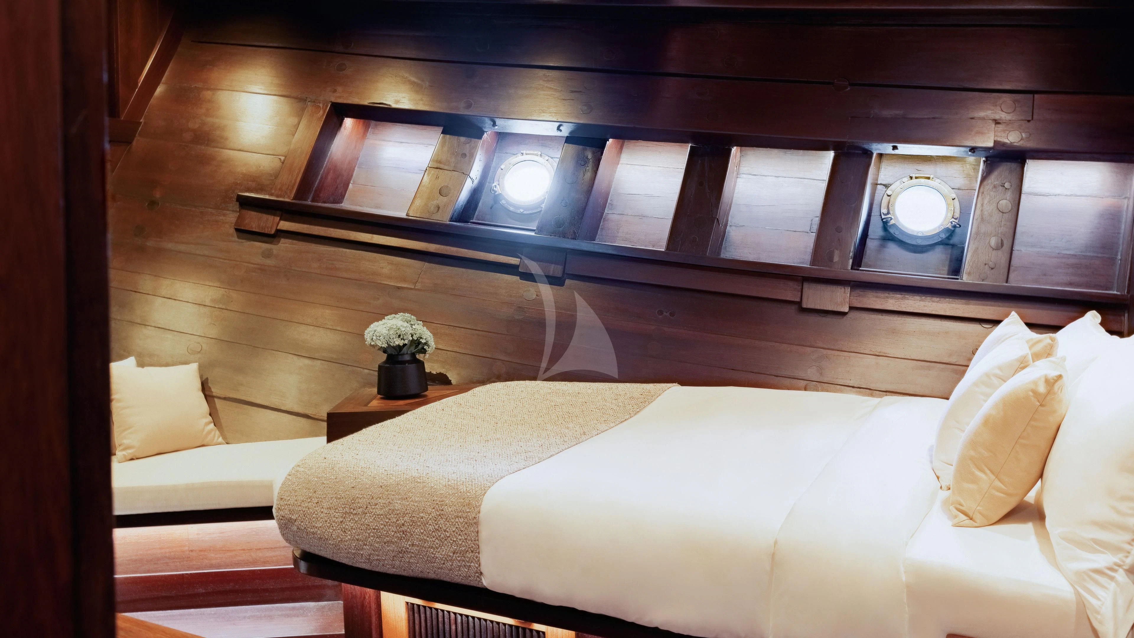 a room with a bed and a window aboard DUNIA BARU Yacht for Charter