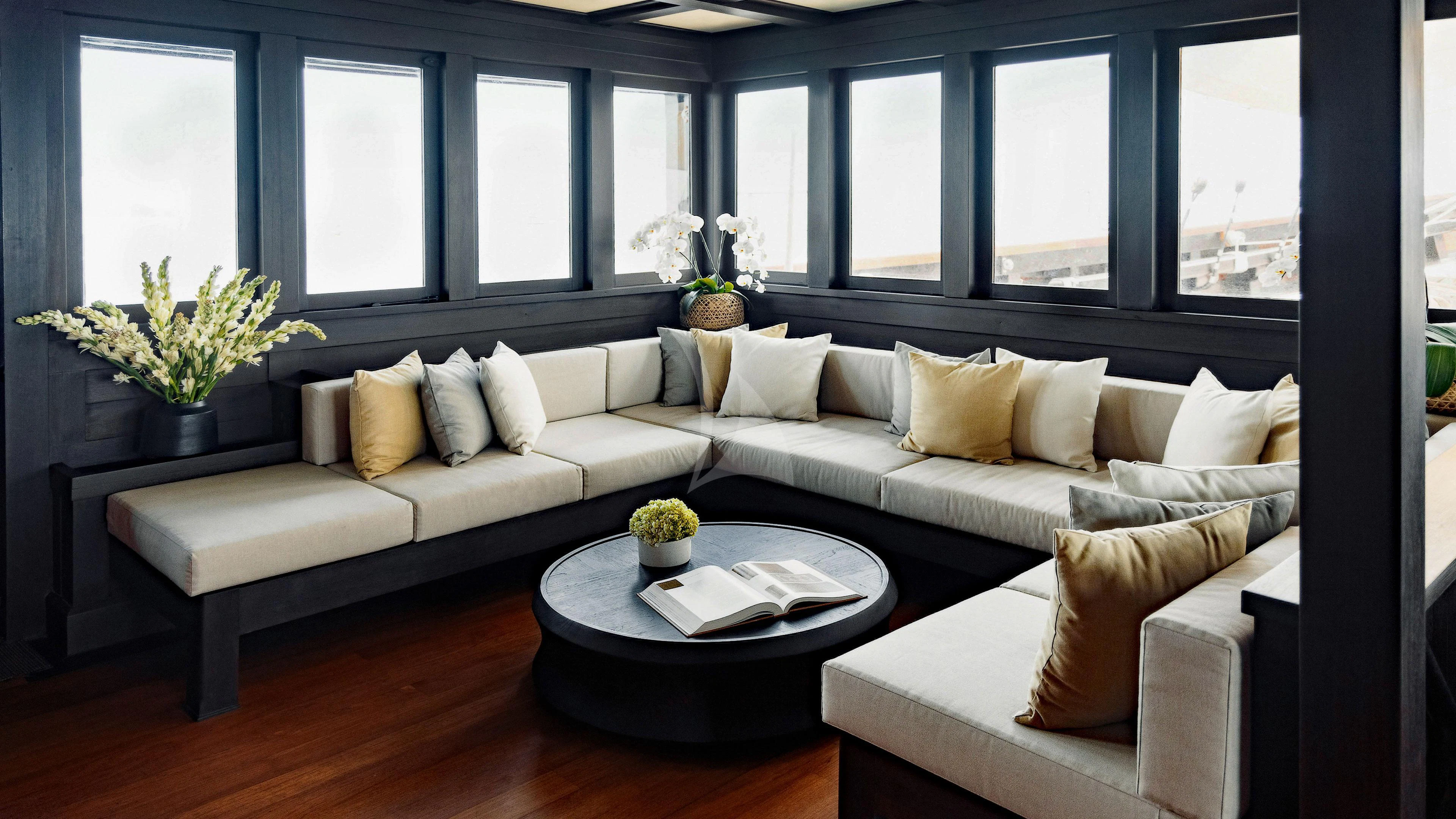 a living room with a couch and a coffee table aboard DUNIA BARU Yacht for Charter
