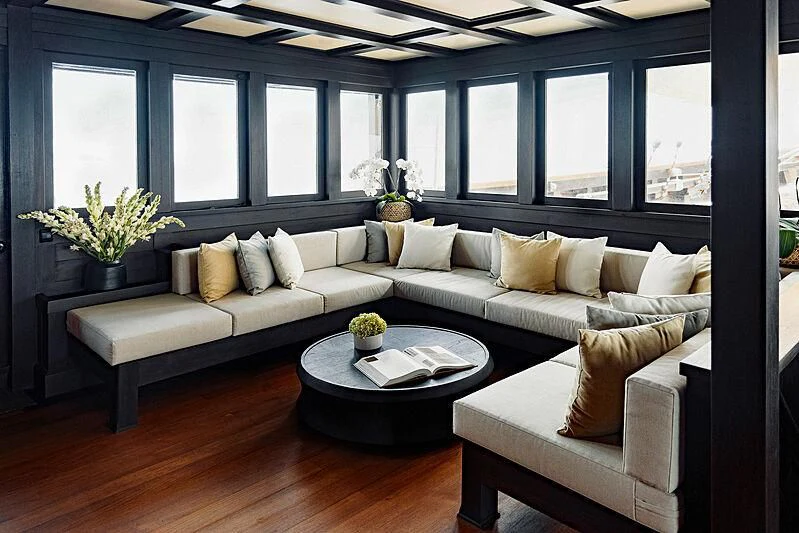 a living room with a couch and a coffee table aboard DUNIA BARU Yacht for Charter