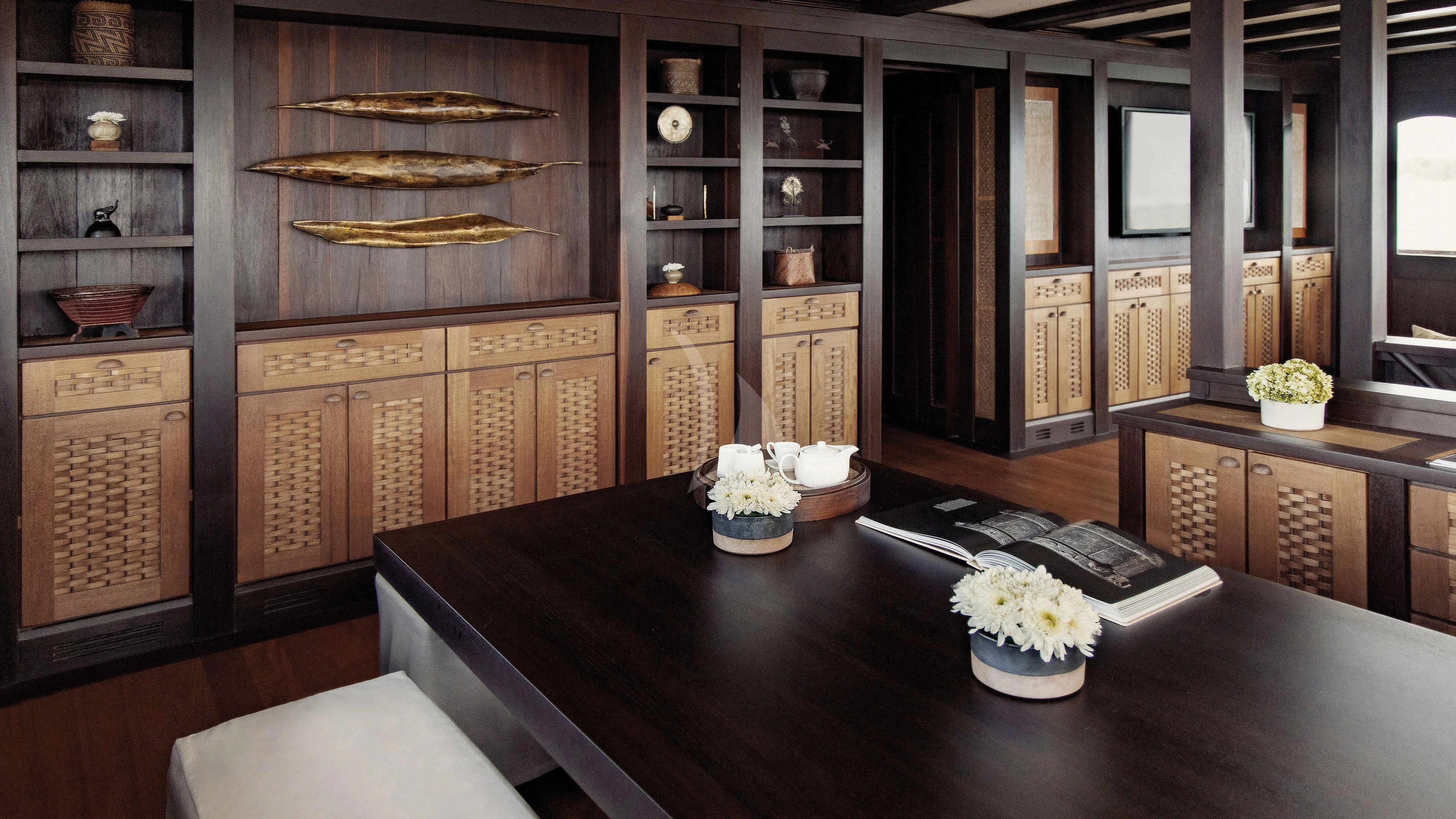a kitchen with a black counter aboard DUNIA BARU Yacht for Charter