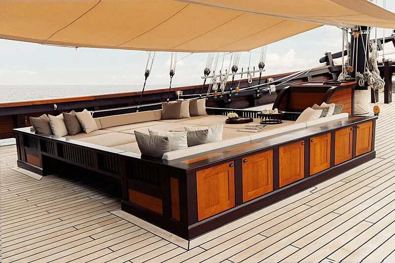 a room with a bed and a couch aboard DUNIA BARU Yacht for Charter