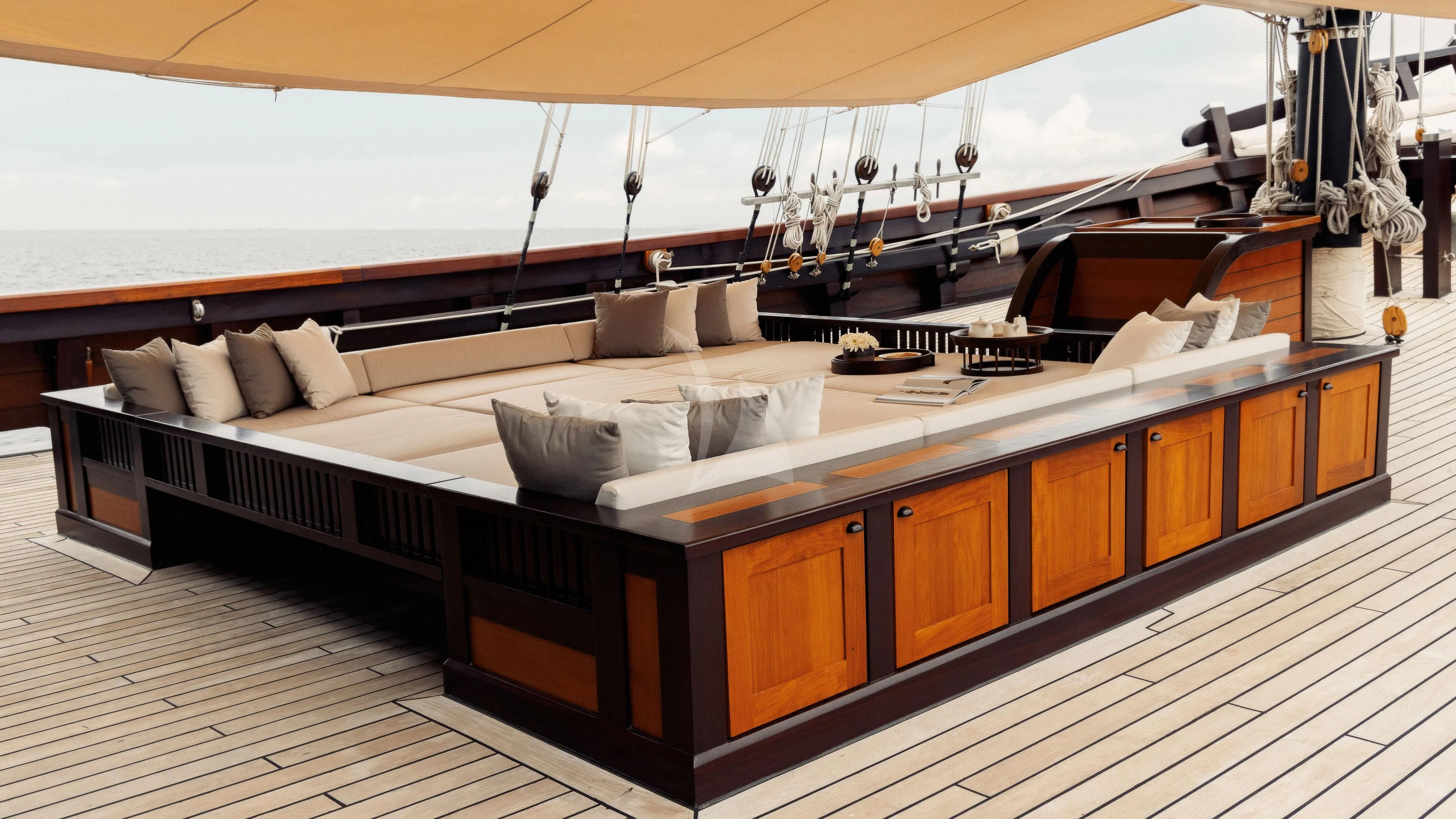 a room with a bed and a couch aboard DUNIA BARU Yacht for Charter