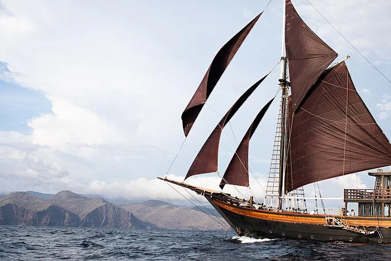 a large sailboat on the water aboard DUNIA BARU Yacht for Charter