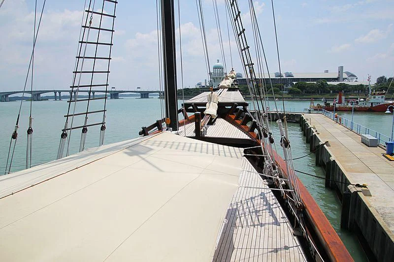 a boat docked at a pier aboard DUNIA BARU Yacht for Charter