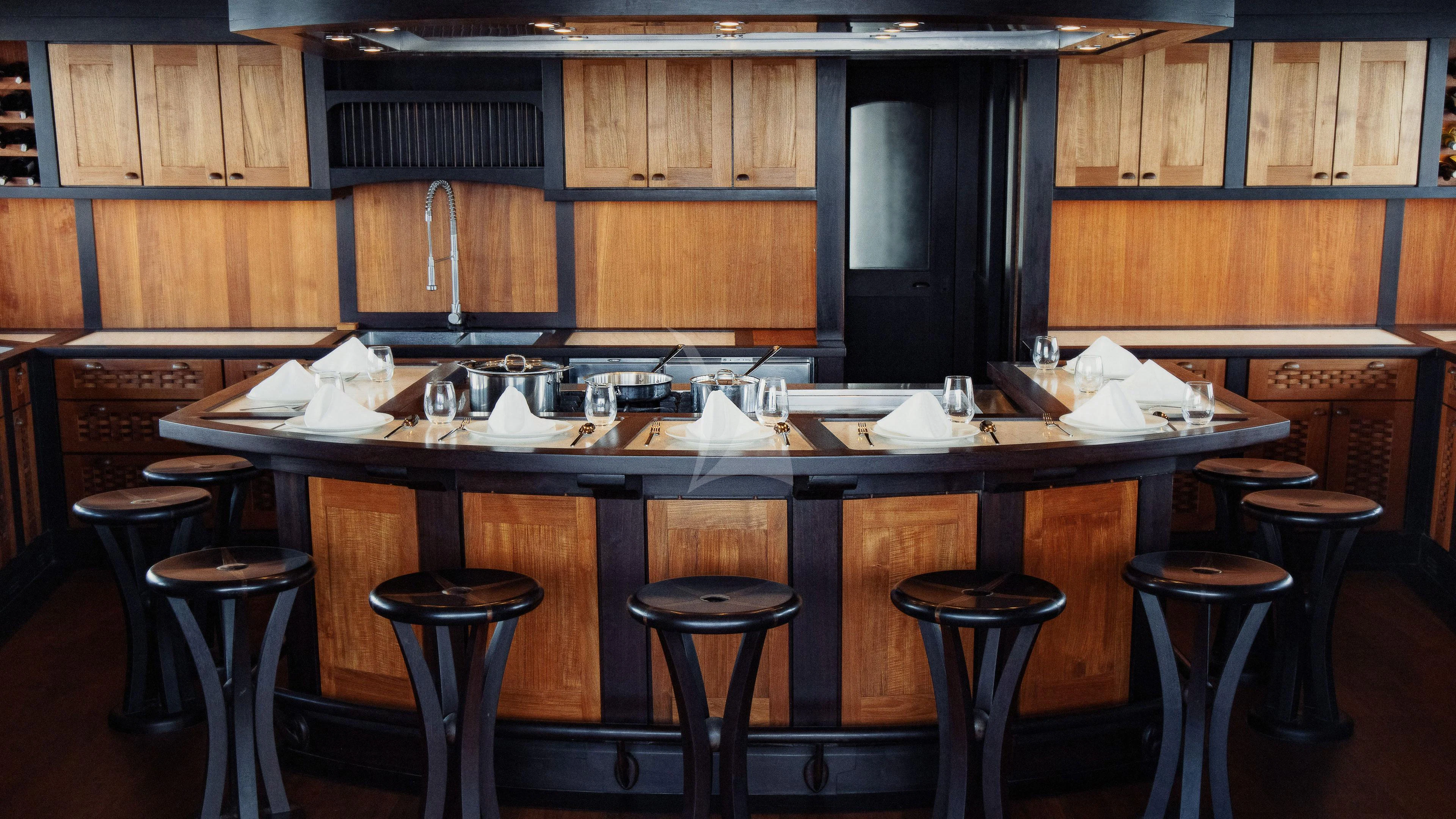 a bar with stools and stools aboard DUNIA BARU Yacht for Charter