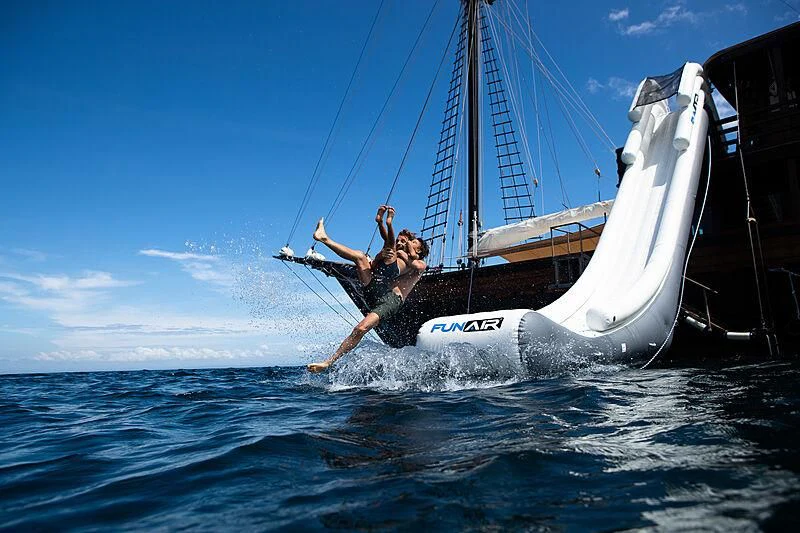 a man on a sailboat aboard DUNIA BARU Yacht for Charter