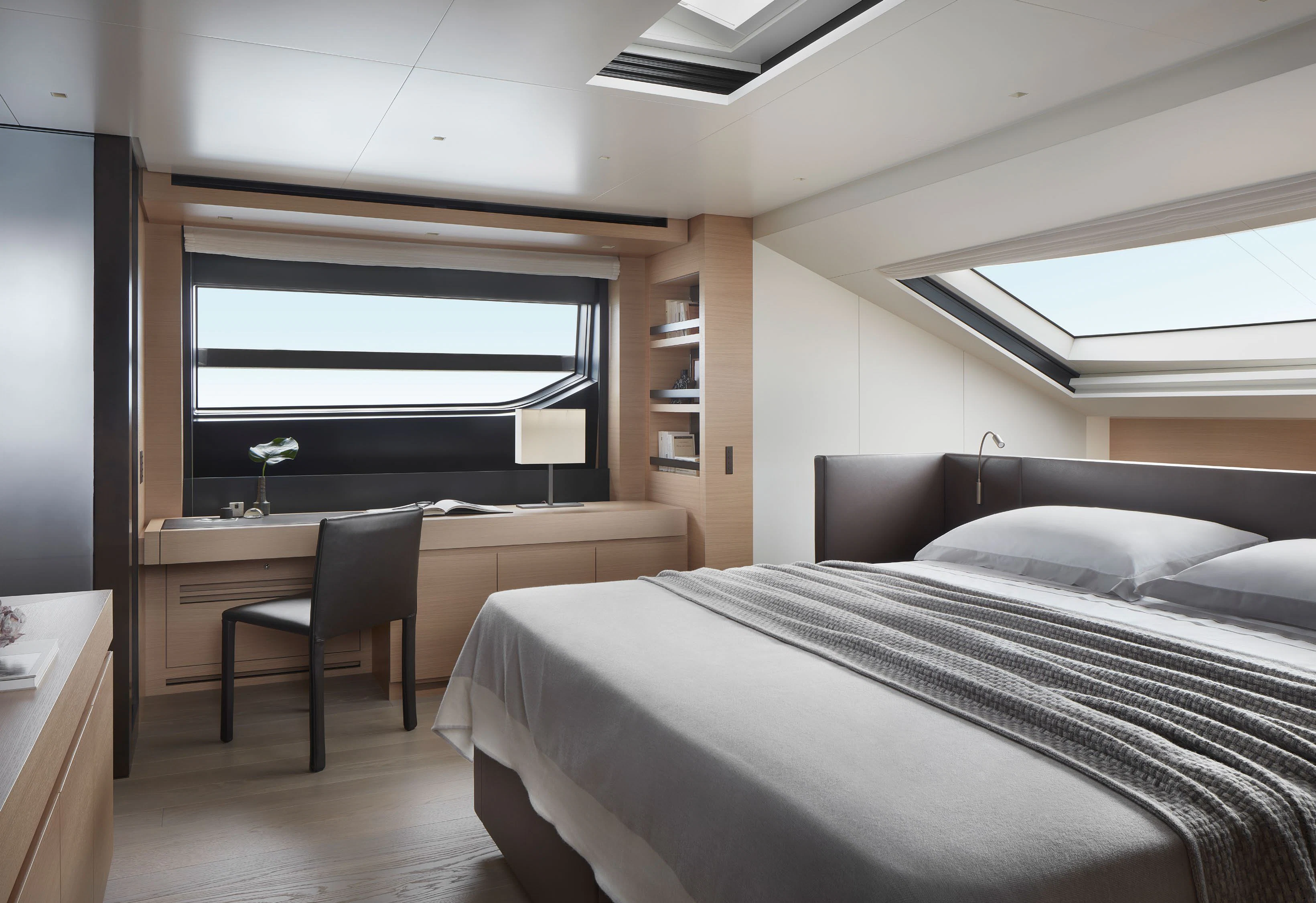 a bedroom with a bed and desk aboard STRA DODO Yacht for Sale
