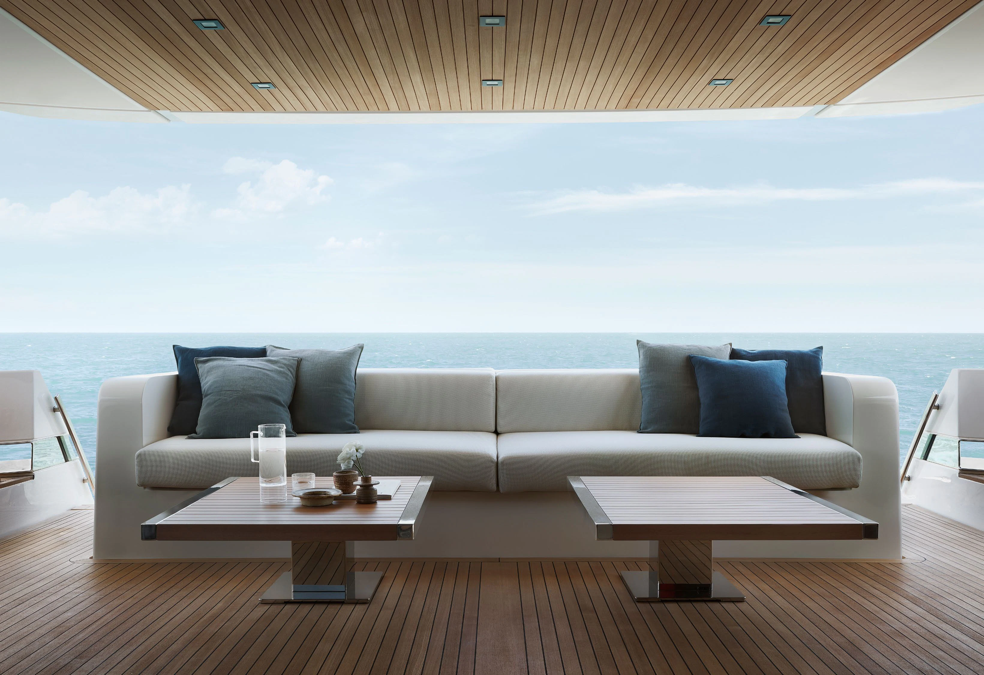 a couch and a table on a deck overlooking the ocean aboard STRA DODO Yacht for Sale