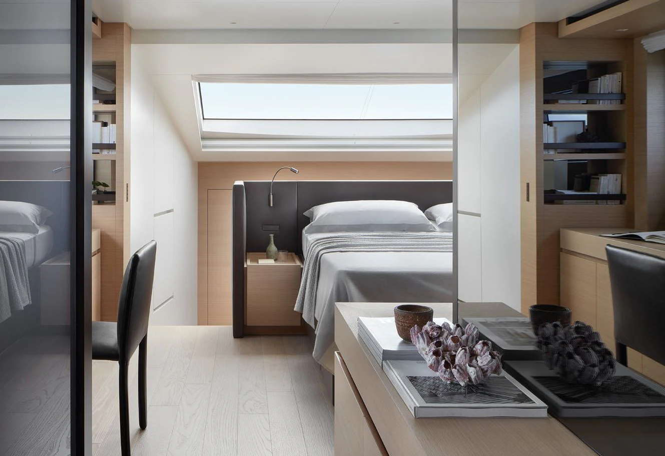 a bedroom with a bed and a desk aboard STRA DODO Yacht for Sale