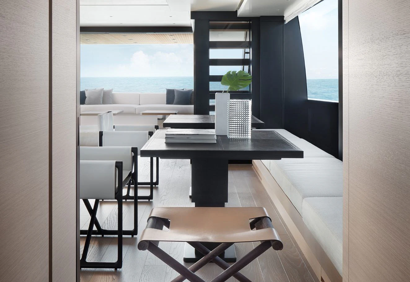 a room with a table and chairs aboard STRA DODO Yacht for Sale