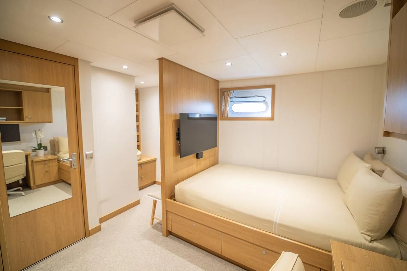 a room with a couch and a television aboard KALM Yacht for Sale