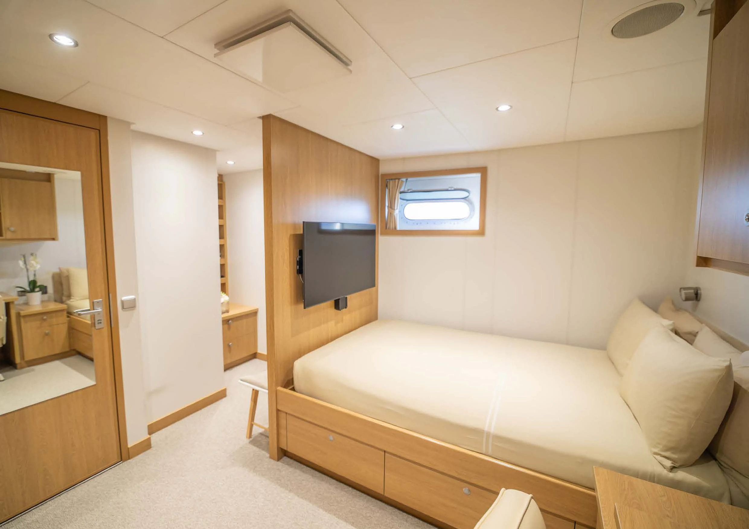 a room with a bed and a television aboard KALM Yacht for Sale