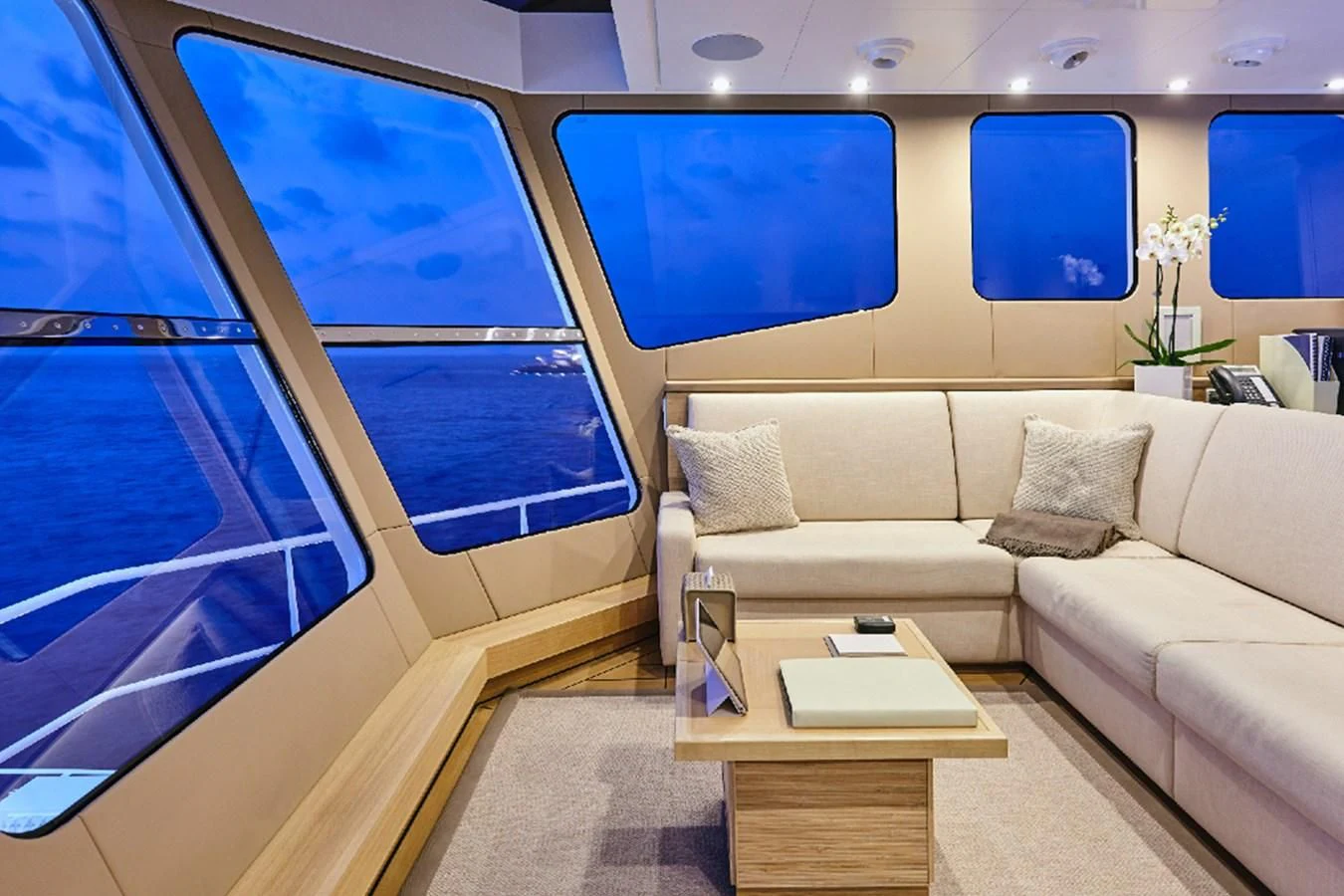 a room with a couch and a table and a window aboard KALM Yacht for Sale