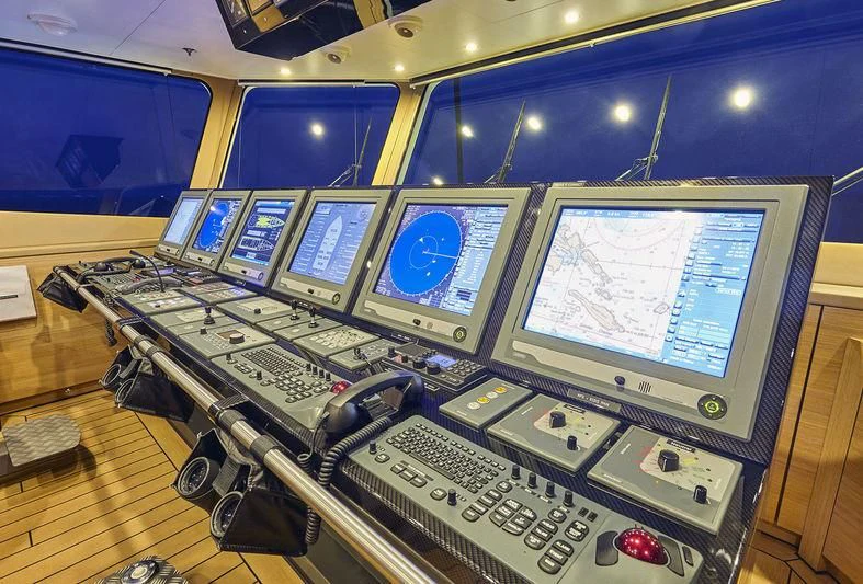 a control room with many monitors aboard KALM Yacht for Sale