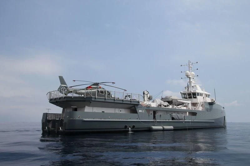 a large ship in the water aboard KALM Yacht for Sale