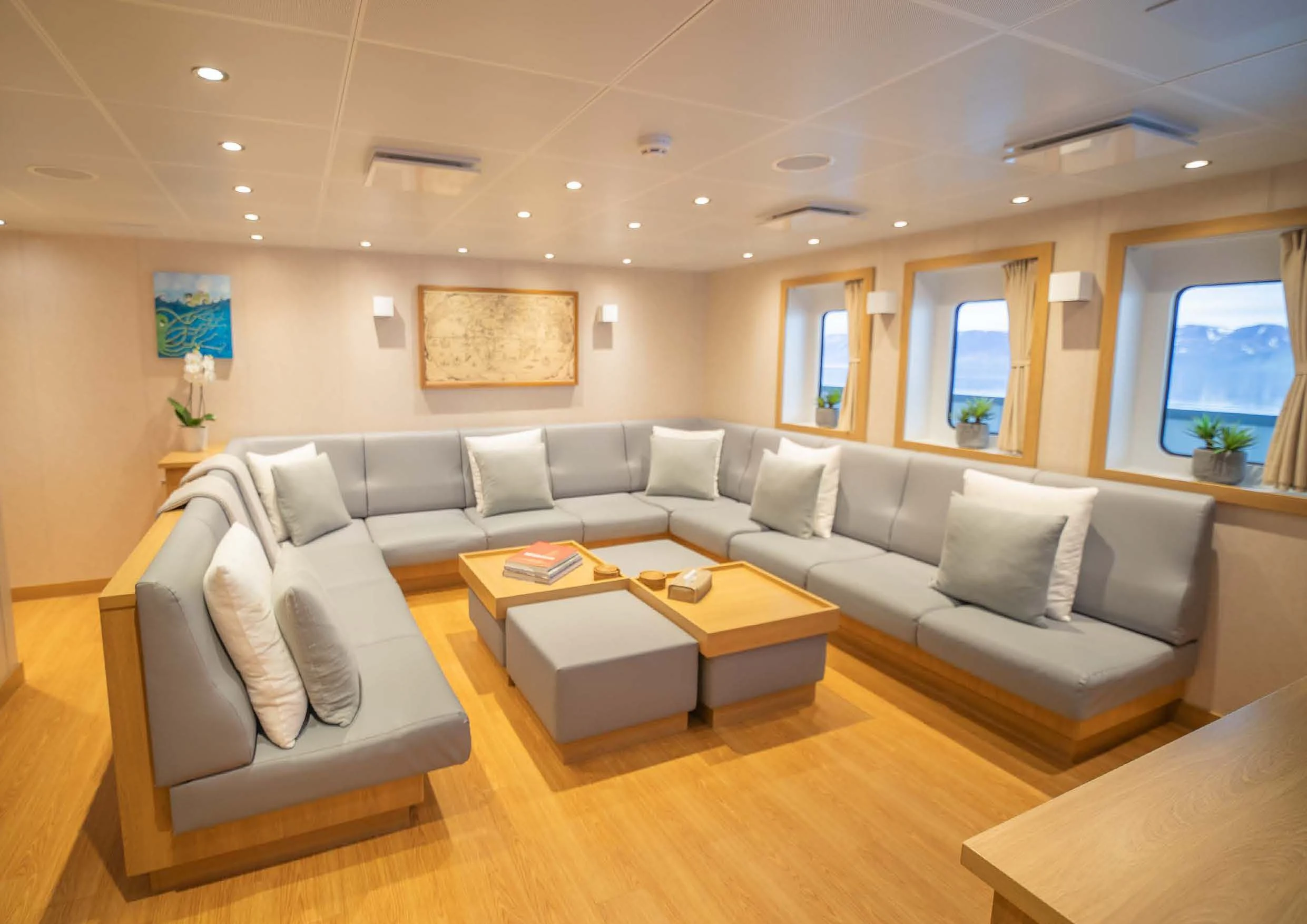 a living room with a couch and a coffee table aboard KALM Yacht for Sale