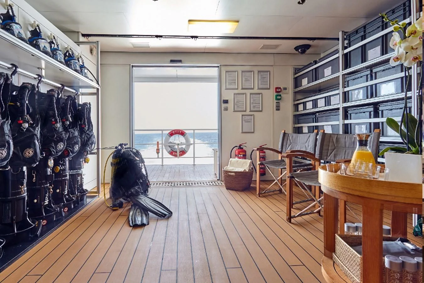 a room with a wood floor and a wood floor with a black bird on it aboard KALM Yacht for Sale