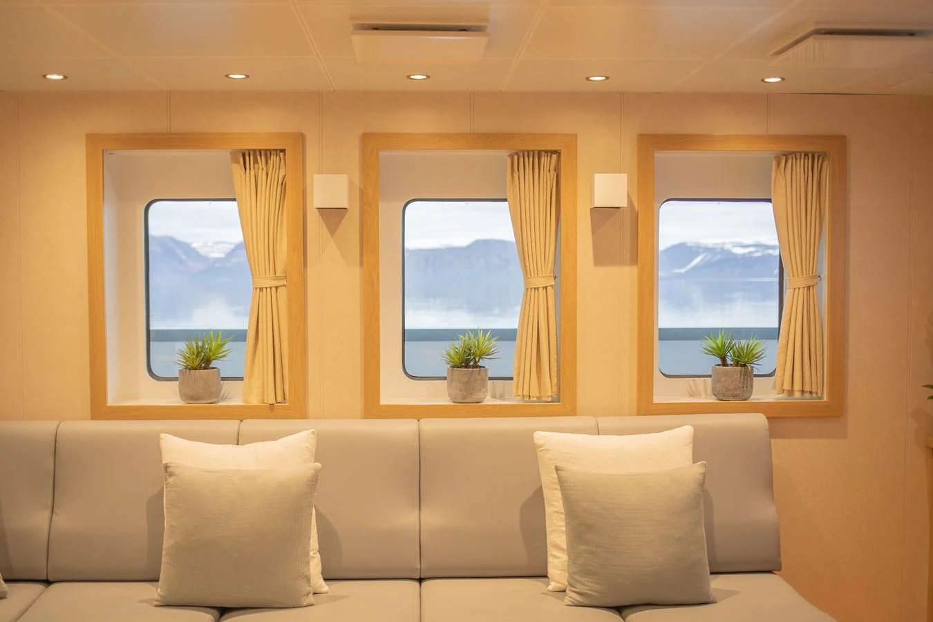 a room with a couch and a window aboard KALM Yacht for Sale