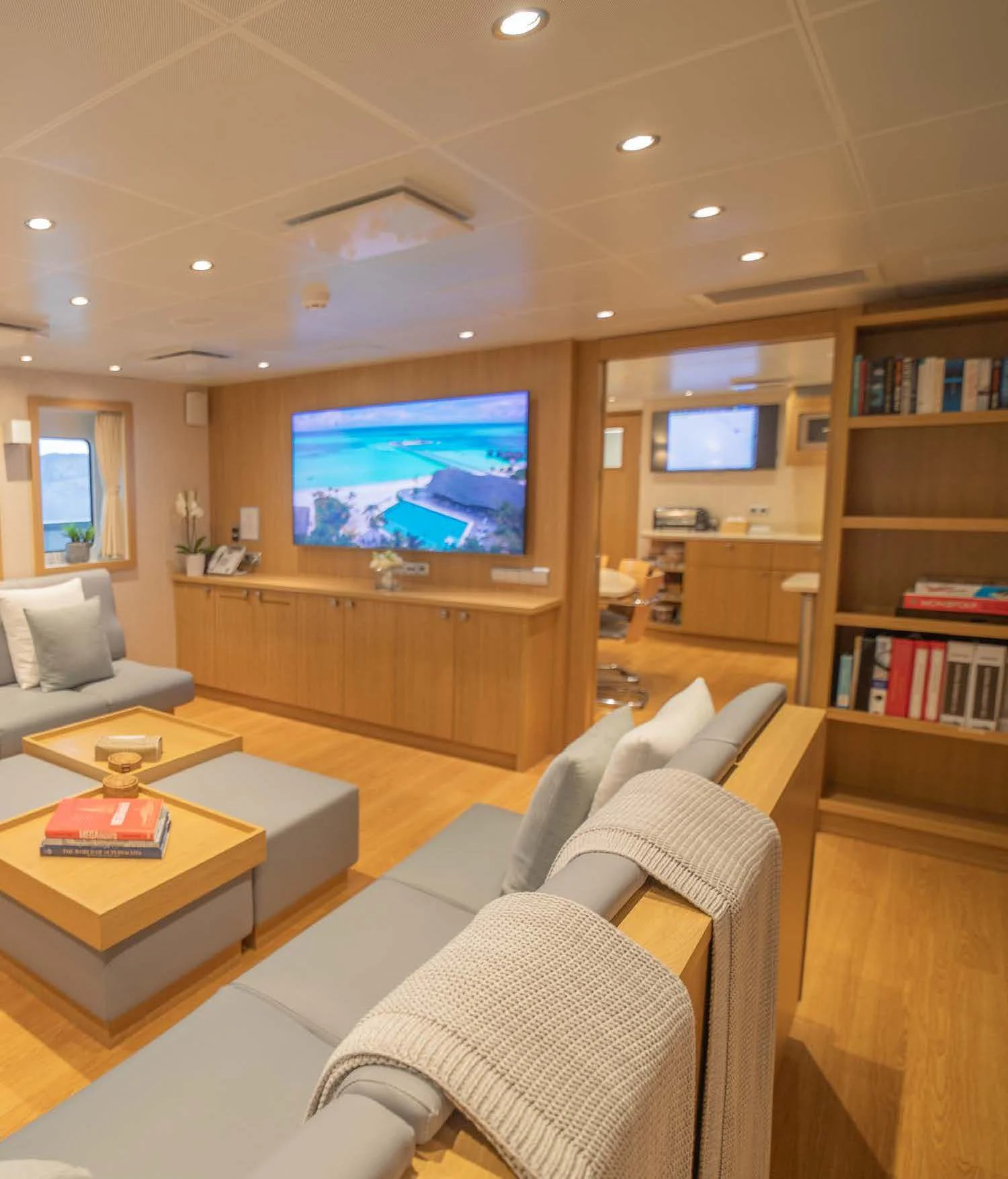 a living room with a tv aboard KALM Yacht for Sale