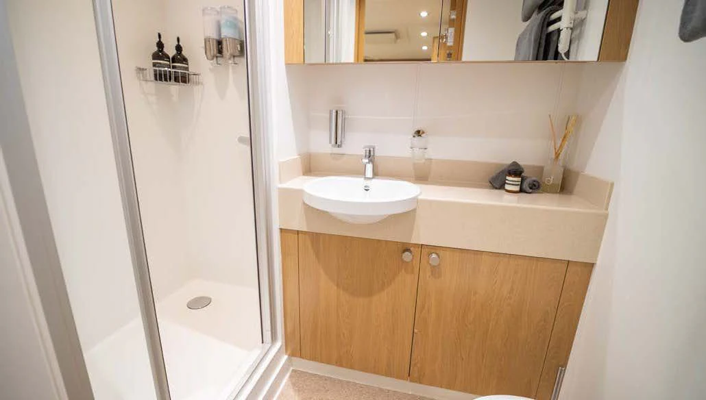 a bathroom with a glass shower door aboard KALM Yacht for Sale