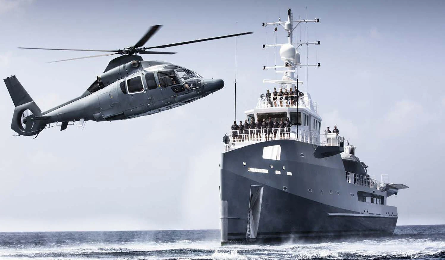 a helicopter flying over a ship aboard KALM Yacht for Sale
