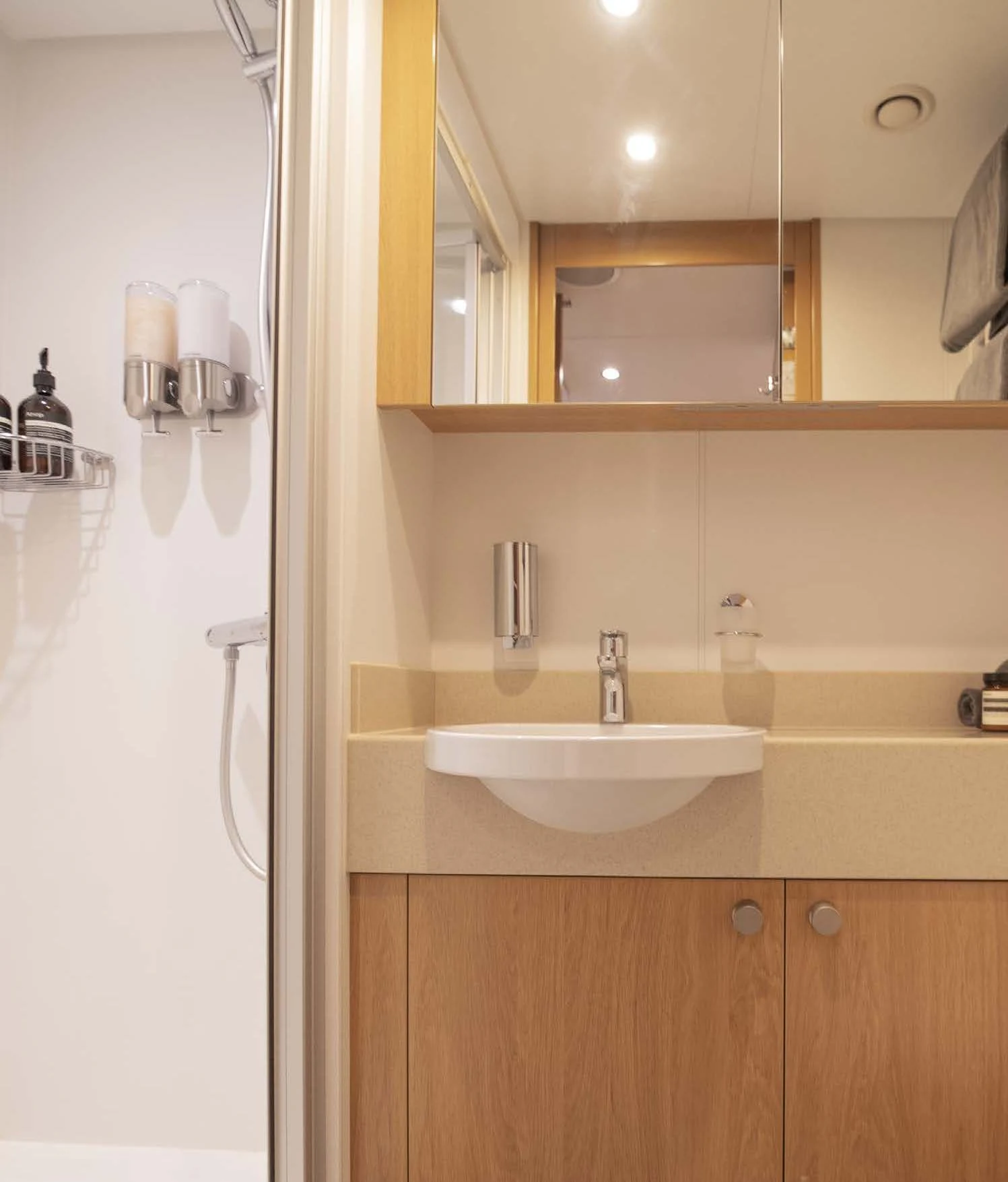 a bathroom with a sink and a mirror aboard KALM Yacht for Sale