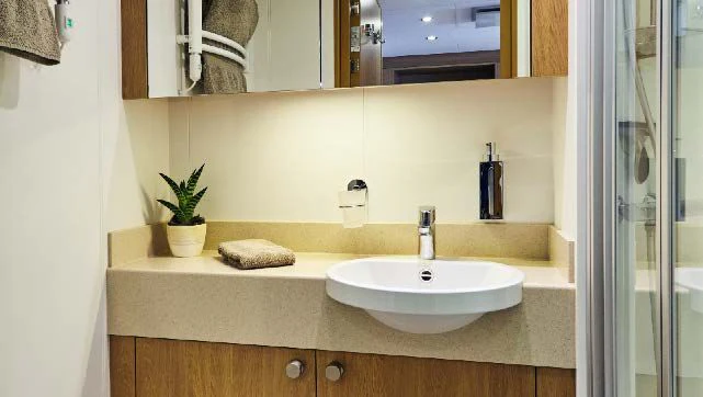 a bathroom with a sink and a mirror aboard KALM Yacht for Sale