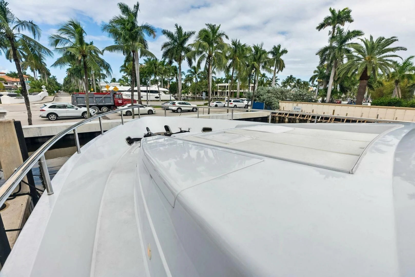 a white roof with a parking lot and palm trees aboard TORTUGA Yacht for Sale