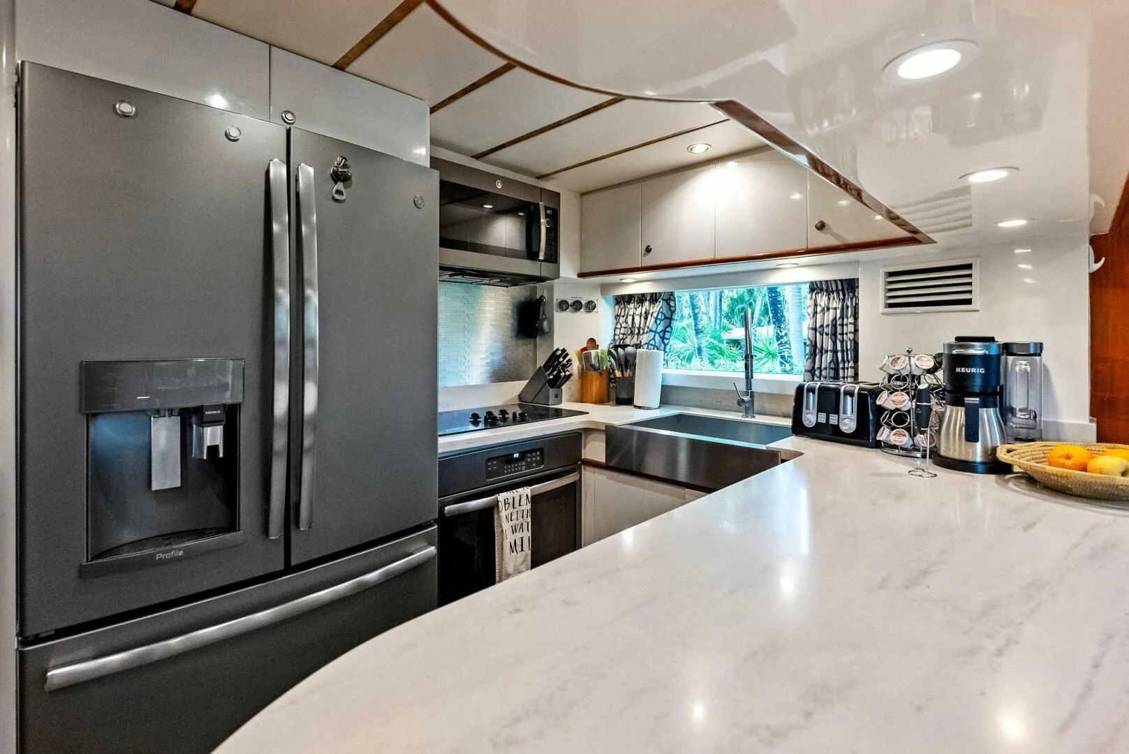 a kitchen with stainless steel appliances aboard TORTUGA Yacht for Sale