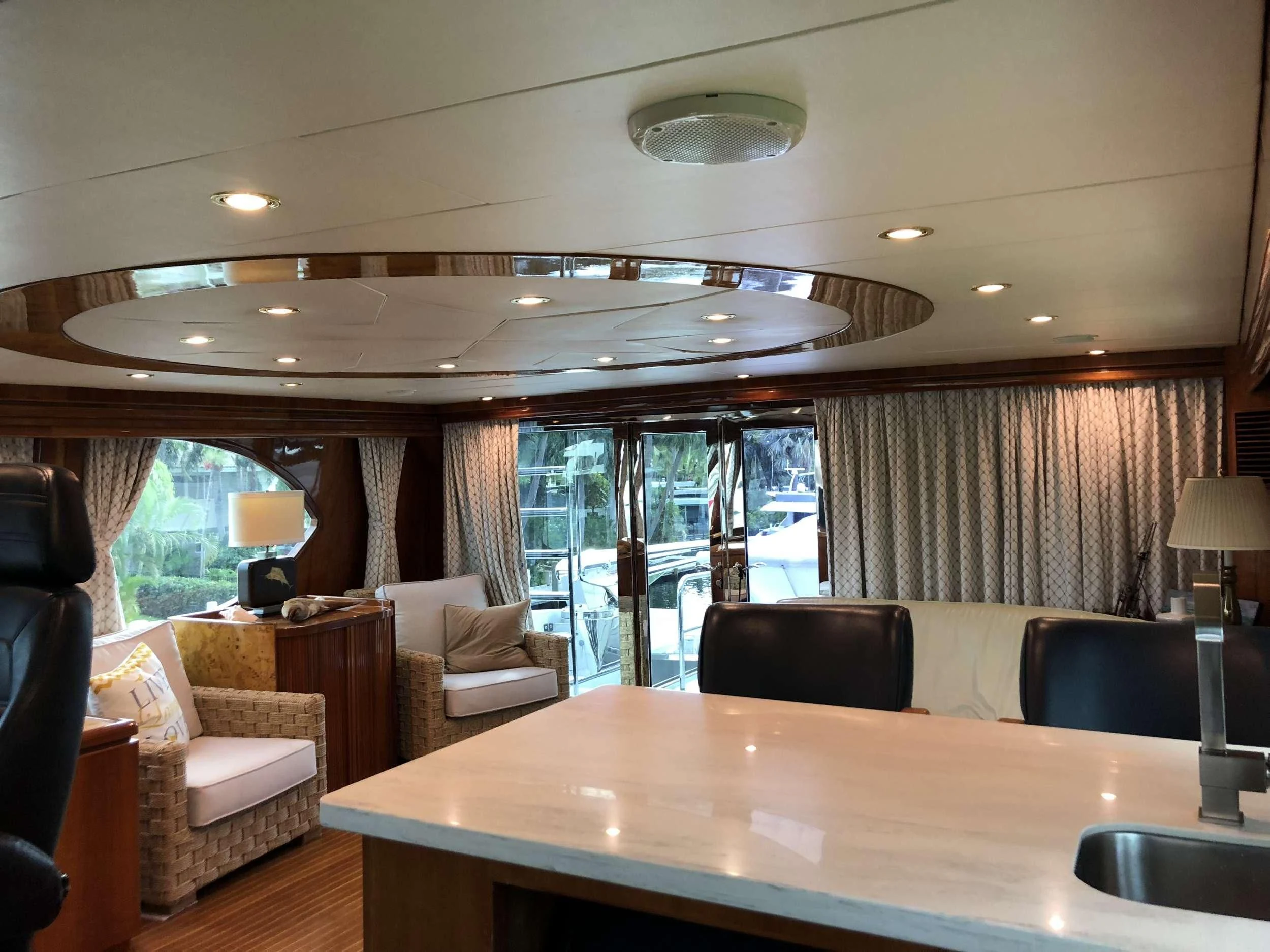 a large room with a table and chairs aboard TORTUGA Yacht for Sale