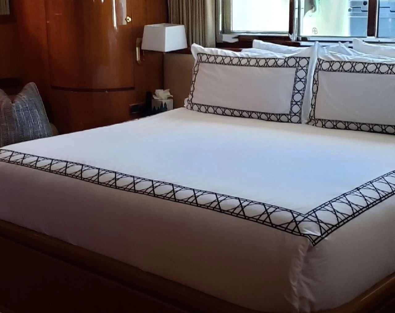 a bed with white sheets aboard TORTUGA Yacht for Sale