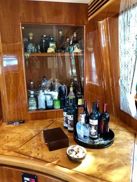 a table with bottles and a mirror aboard TORTUGA Yacht for Sale