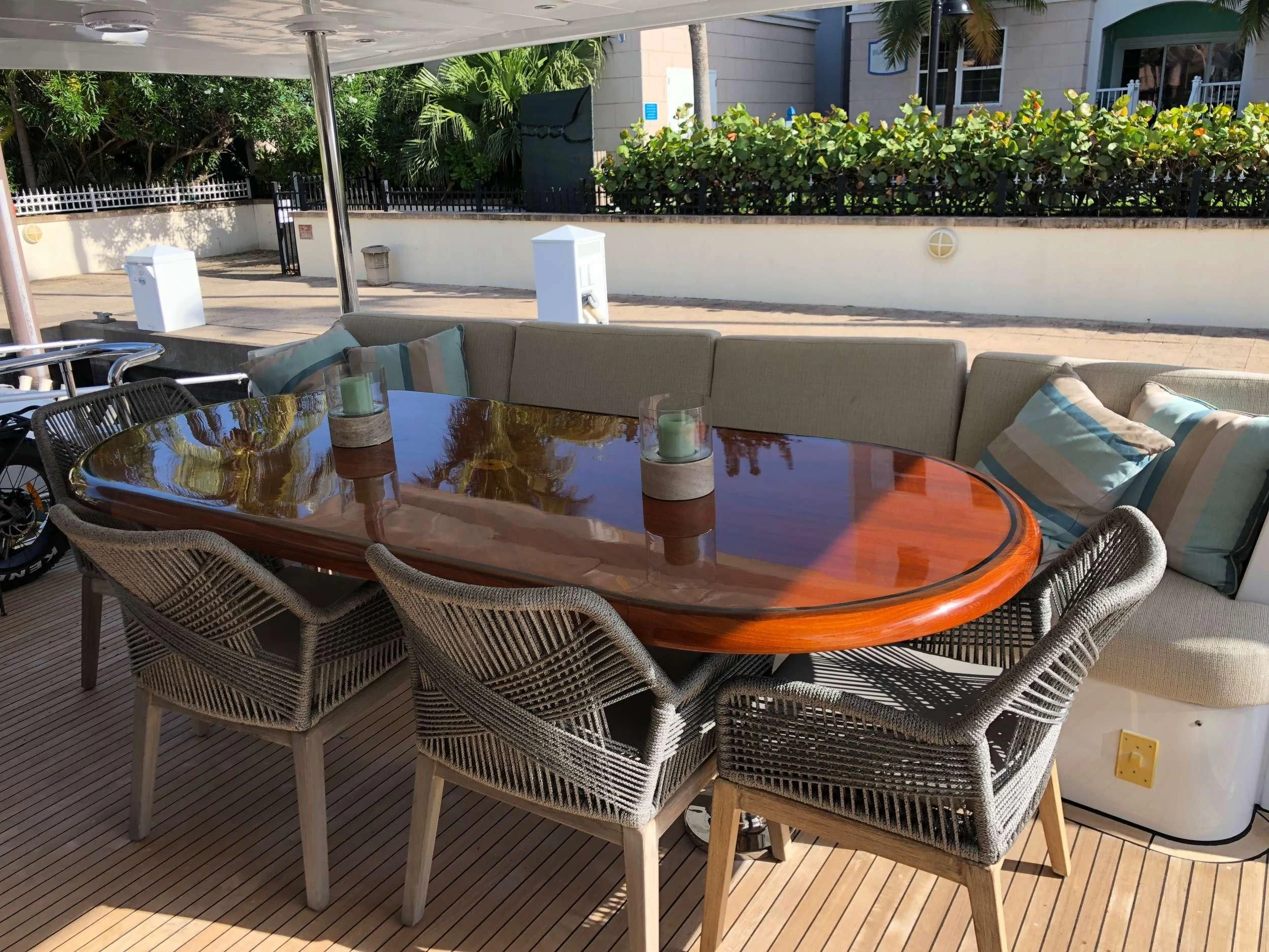 a table and chairs outside aboard TORTUGA Yacht for Sale