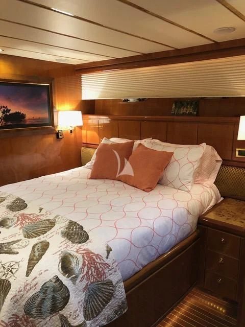a bed with a white comforter aboard TORTUGA Yacht for Sale