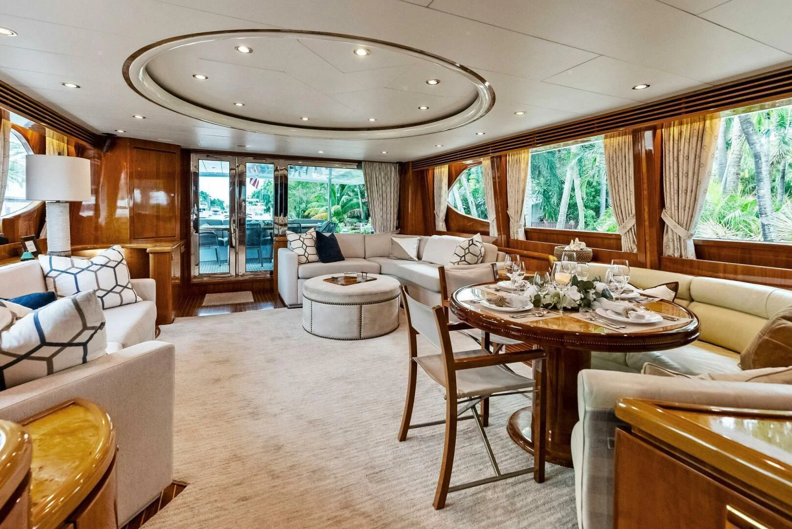 a large living room with a large dining table and chairs aboard TORTUGA Yacht for Sale