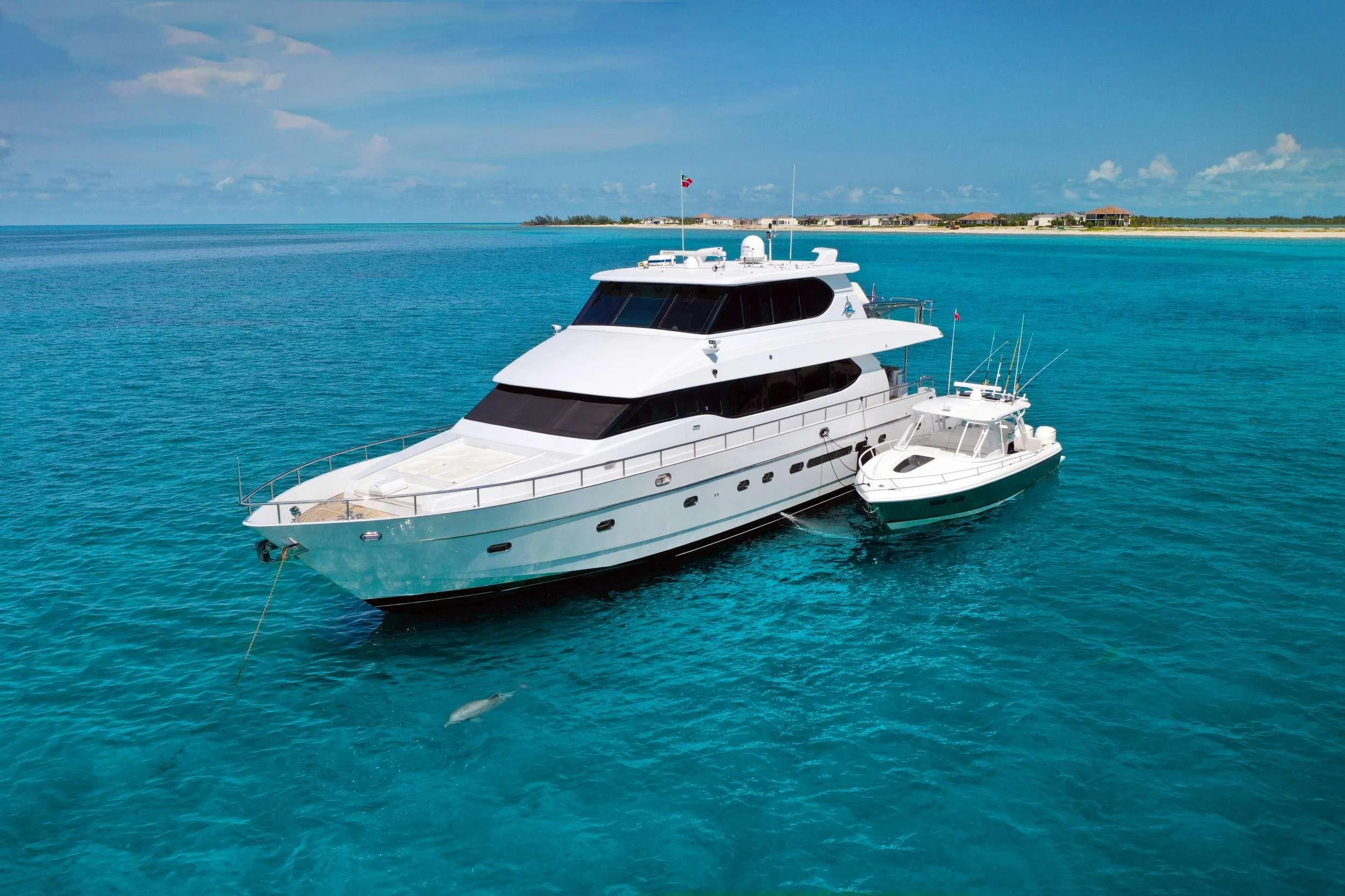 a couple of white yachts in the water aboard TORTUGA Yacht for Sale