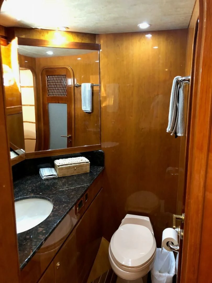 a bathroom with a toilet and a sink aboard TORTUGA Yacht for Sale