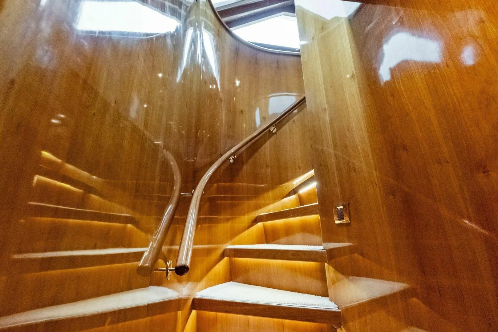 a wooden staircase with a metal railing aboard TORTUGA Yacht for Sale