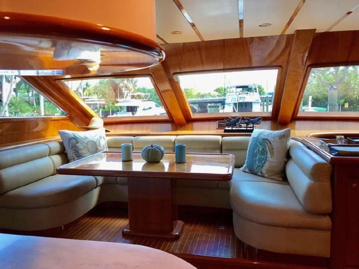 a living room with a table and couches aboard TORTUGA Yacht for Sale